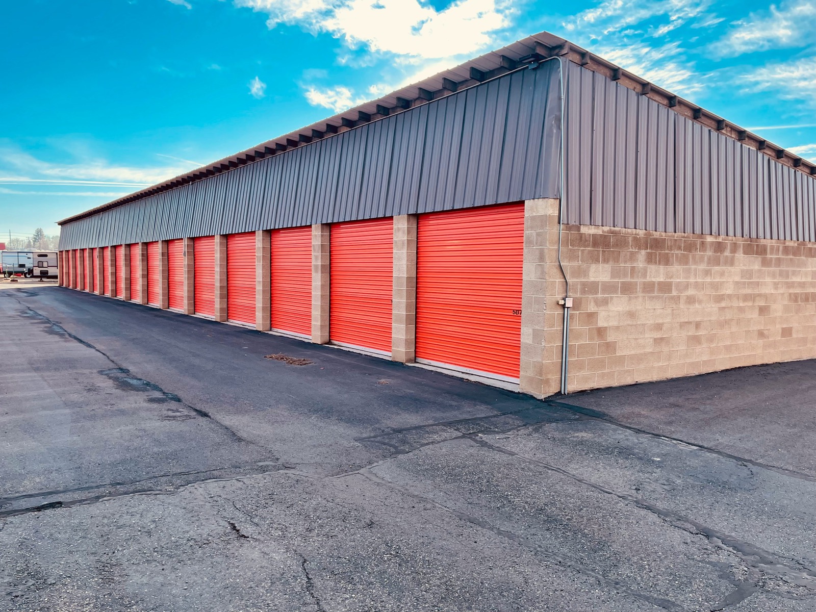 Row of self-storage units with roll-up doors, a typical drive-up storage facility.
